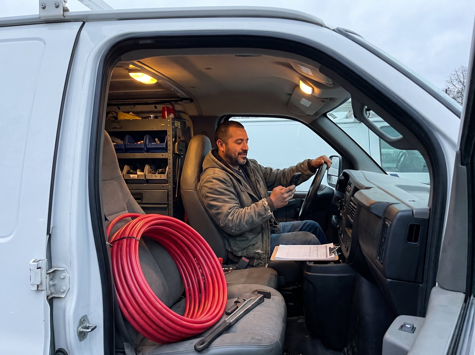 Plumber in his work van texting a customer a Google review link right after the job